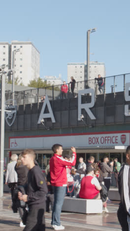 Vertical-Video-Of-The-Emirates-Stadium-Home-Ground-Arsenal-Football-Club-London-With-Supporters-On-Match-Day